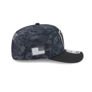 A New Era 9FIFTY fitted cap featuring a dark digital camouflage pattern on the crown and a solid black brim. The side displays a white embroidered 'NY' logo and a black-and-white American flag patch.
