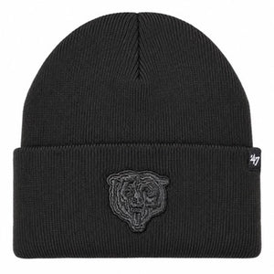 A black ribbed knit beanie hat featuring an embossed dark gray embroidered Chicago Bears tiger logo on the front cuff and a small white '47 brand tag on the right side of the cuff.