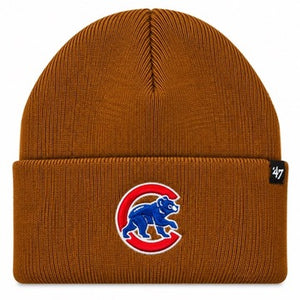 A ribbed knit beanie hat in a warm brownish-orange color, featuring the Chicago Cubs logo embroidered on the front cuff. A small black '47 brand tag is visible on the right side of the cuff.