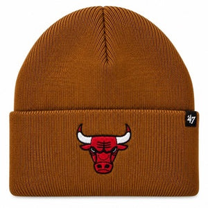A ribbed knit beanie hat in a warm brownish-orange color, featuring an embroidered Chicago Bulls logo on the front cuff and a small black '47 brand tag on the right side.