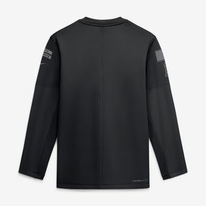 A black long-sleeve athletic shirt shown from the back, featuring a crew neck, subtle seam detailing, and small gray sleeve graphics, photographed on a light gray background.