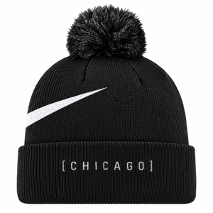 A black knit pom-pom beanie featuring a white Nike Swoosh on the side and '[CHICAGO]' printed in white on the front cuff.