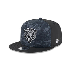 A New Era 9FIFTY snapback cap featuring a dark blue and black digital camouflage pattern on the front panels, a black brim, a black side panel, and a white embroidered Chicago Bears bear head logo on the front. A white New Era flag logo is visible on the side.
